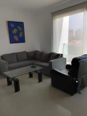 a living room with a couch and a table at Bijao 4a in Barranquilla