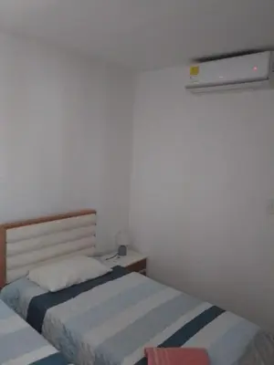 a small bedroom with two beds and a heater at Bijao 4a in Barranquilla