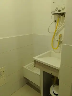 a white bathroom with a sink and a toilet at Bijao 4a in Barranquilla