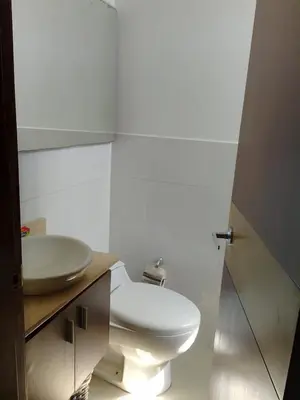 a bathroom with a white toilet and a sink at Bijao 4a in Barranquilla