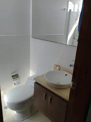 a bathroom with a white toilet and a sink at Bijao 4a in Barranquilla