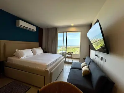 a hotel room with a bed and a flat screen tv at Apartamento de Lujo en Santa Marta con vista al mar -Santamarina- 1802 in Santa Marta