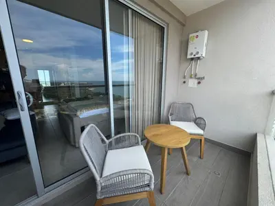 a room with a table and chairs and a window at Apartamento de Lujo en Santa Marta con vista al mar -Santamarina- 1802 in Santa Marta