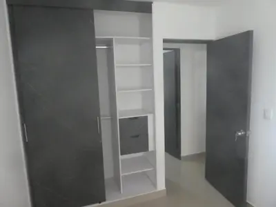 a closet with white shelves and a gray wall at Cómodo apartamento cerca de la playa & central in Cartagena de Indias