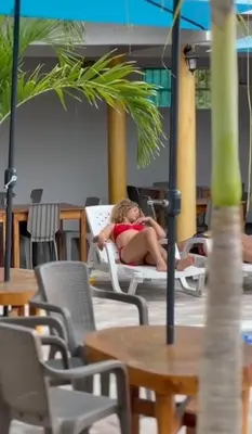 a woman in a bikini sitting in a chair at Casa Mariana Hostel Boutique in Santa Marta