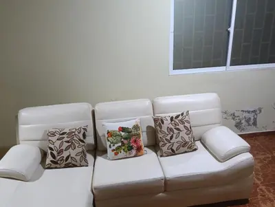 a white couch with three pillows on it at Apto country in Cartagena de Indias