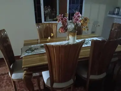 a dining room table with a vase of flowers on it at Apto country in Cartagena de Indias