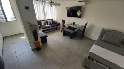 a living room with a couch and a table at Apartamento Cerca a la playa, Piscina, Wifi, AC in Cartagena de Indias