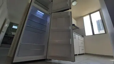 a stainless steel refrigerator in a kitchen with a window at Apartamento Cerca a la playa, Piscina, Wifi, AC in Cartagena de Indias