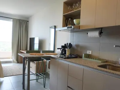 a kitchen with a counter with two pizzas on it at Santa Marta apartamento frente al mar -Santamarina- 1202 in Santa Marta