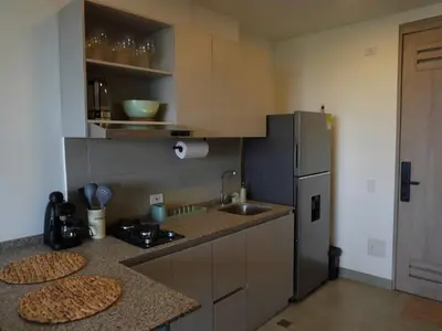 a kitchen with a refrigerator and a counter top at Santa Marta apartamento frente al mar -Santamarina- 1202 in Santa Marta