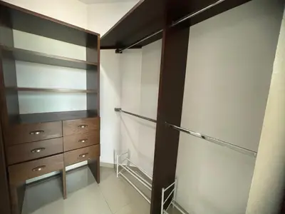 a walk in closet with a dresser and cabinets at Bijao 6b in Barranquilla