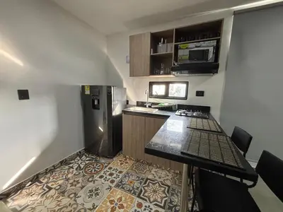 a small kitchen with a stove and a refrigerator at Coral Tower 603 in Barranquilla