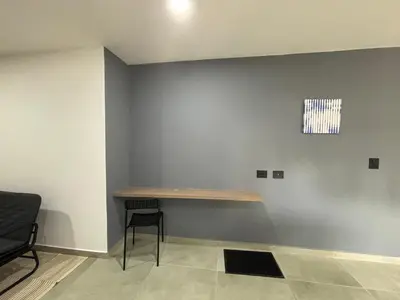 a room with a table on the wall with a chair at Coral Tower 603 in Barranquilla
