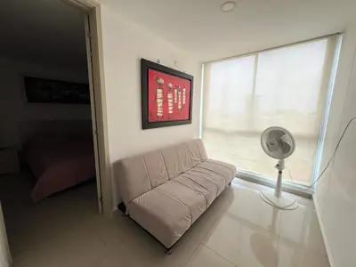 a living room with a couch and a fan at Kairos 1209 in Barranquilla