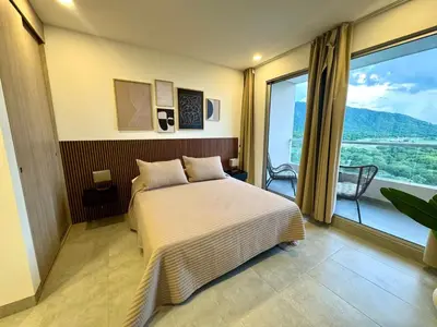 a bedroom with a bed and a large window at Apartamento con vistas al mar-SantaMarina-1303 in Santa Marta