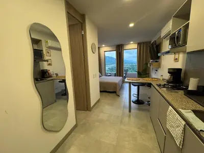 a kitchen with a mirror and a living room at Apartamento con vistas al mar-SantaMarina-1303 in Santa Marta