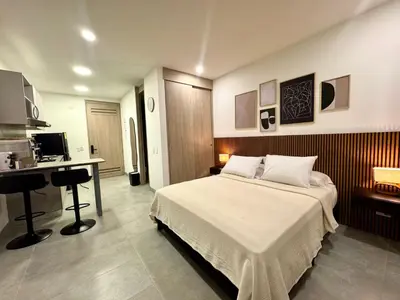 a bedroom with a bed and a desk in it at Apartamento con vista,piscina y playa -SantaMarina-803 in Santa Marta