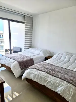 two beds in a bedroom with a large window at Morros Eco in Cartagena de Indias