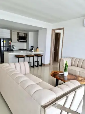 a living room with a white couch and a table at Morros Eco in Cartagena de Indias