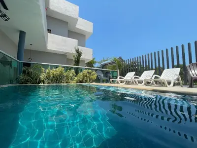 a swimming pool in front of a building at Apartaestudio Terraza del Sol 101 in Coveñas