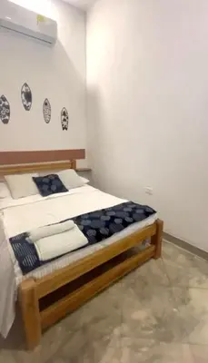a bedroom with a wooden bed in a room at Apartaestudio Terraza del Sol 101 in Coveñas