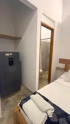 a bedroom with a bed and a mirror at Apartaestudio Terraza del Sol 101 in Coveñas