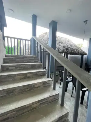 a set of stairs in a house with a table and chairs at Apartaestudio Terraza del Sol 101 in Coveñas