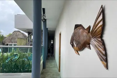 a fish sculpture on the wall of a building at Apartaestudio Terraza del Sol 101 in Coveñas