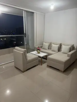 a living room with a couch and chairs and a window at Apartamento moderno con una increíble vista en zona exclusiva de la ciudad de Barranquilla in Barranquilla