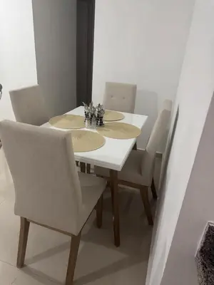 a white dining room table with chairs and a white table and chairsktop at Apartamento moderno con una increíble vista en zona exclusiva de la ciudad de Barranquilla in Barranquilla