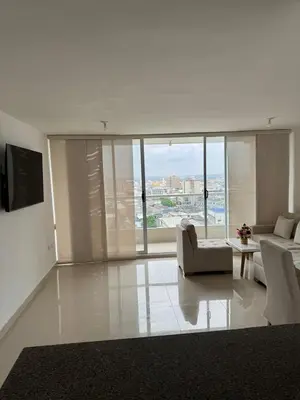 a living room with a couch and a table at Apartamento moderno con una increíble vista en zona exclusiva de la ciudad de Barranquilla in Barranquilla