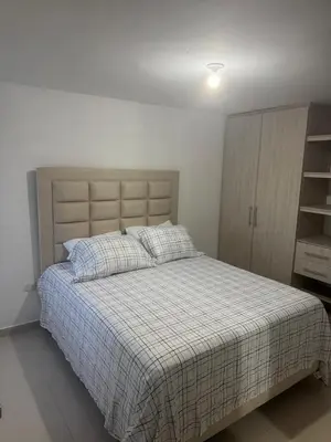 a bedroom with a bed and a cabinet in it at Apartamento moderno con una increíble vista en zona exclusiva de la ciudad de Barranquilla in Barranquilla