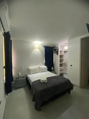 a bedroom with a bed with two towels on it at Exclusive Caribbean Retreat Serena Del Mar in Cartagena de Indias