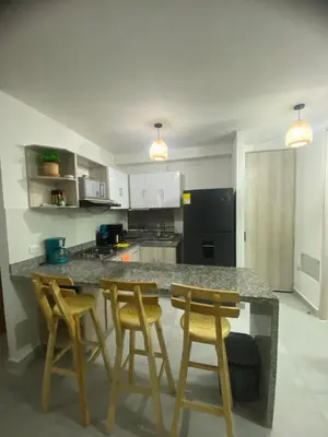 a kitchen with a counter with four chairs around it at Exclusive Caribbean Retreat Serena Del Mar in Cartagena de Indias