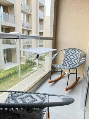a table and a chair on a balcony at Exclusive Caribbean Retreat Serena Del Mar in Cartagena de Indias