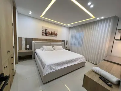 a bedroom with a large white bed in a room at Blue Gardens in Barranquilla