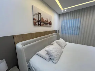 a bedroom with a white bed with a picture on the wall at Blue Gardens in Barranquilla
