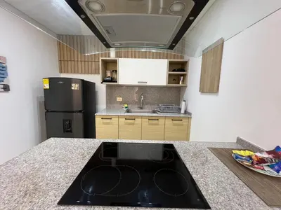 a kitchen with a black stove top in a kitchen at Blue Gardens in Barranquilla