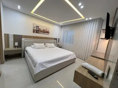 a bedroom with a bed and a television in it at Blue Gardens in Barranquilla
