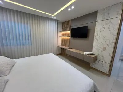 a bedroom with a bed and a flat screen tv at Blue Gardens in Barranquilla