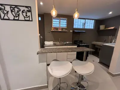 a kitchen with two bar stools and a counter top at Edificio Quintero in Barranquilla