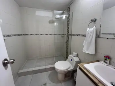 a bathroom with a toilet and a shower and a sink at Edificio Quintero in Barranquilla
