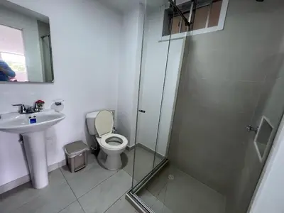 a bathroom with a shower and a toilet and a sink at Tarapaca in Barranquilla