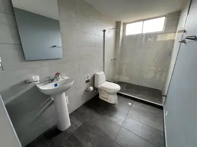 a bathroom with a toilet and a sink and a shower at Tarapaca in Barranquilla