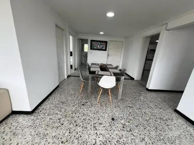 a dining room with a table and chairs in a room at Tarapaca in Barranquilla