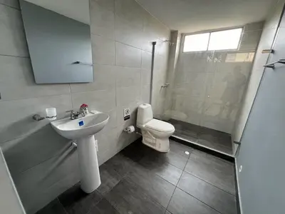 a bathroom with a toilet and a sink and a shower at Tarapaca in Barranquilla