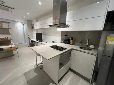 a kitchen with white cabinets and a counter top at Distrito 90 in Barranquilla
