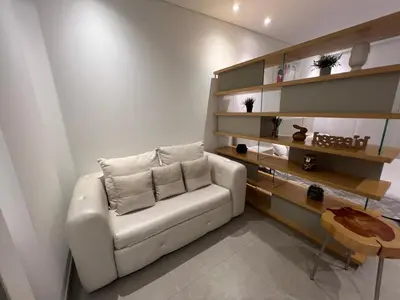 a living room with a white couch and a table at Distrito 90 in Barranquilla