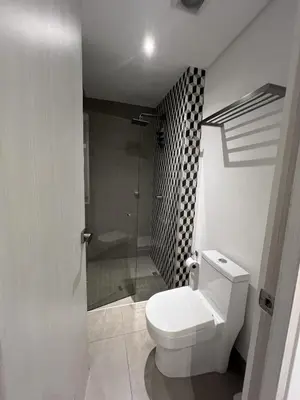 a bathroom with a white toilet and a shower at Distrito 90 in Barranquilla